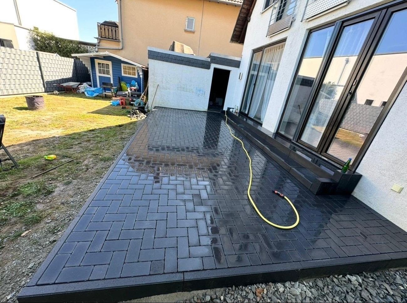 Terrasse mit anthrazitfarbenem Pflaster im Fischgrätverband